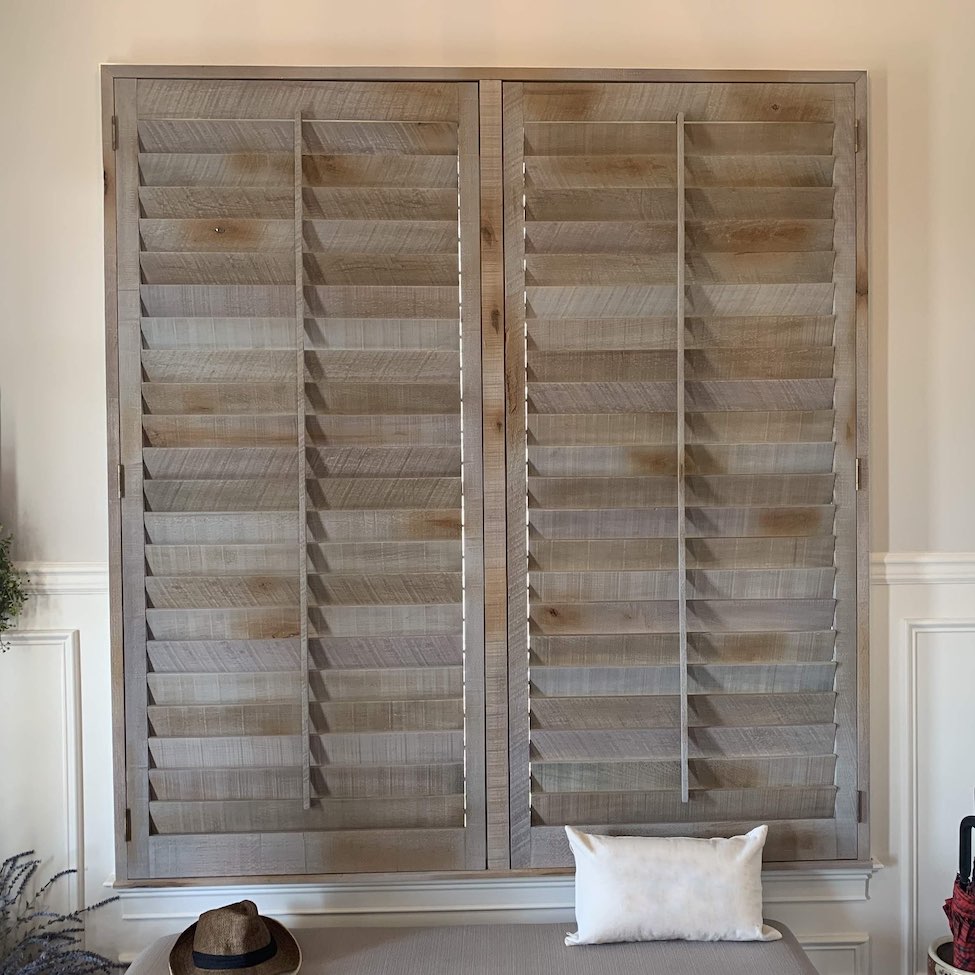 Reclaimed wood shutters above bench
