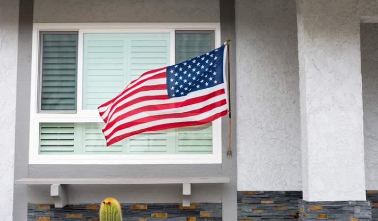 Items manufactured within the US borders are certified by the FTC. Alt Text: American flag flying in front of a home