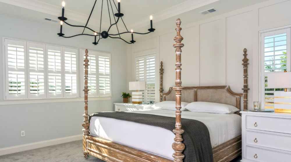Polywood® shutters are a great option when you want a clean and fresh look. Plantation shutters in a bedroom.